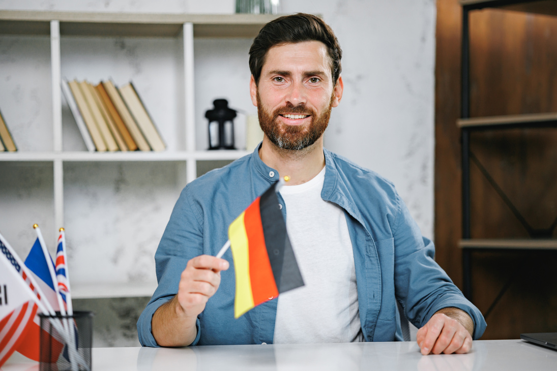 Male Tutor Holding Germany Flag