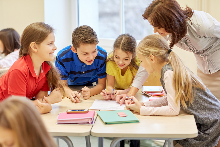 Group of School Kids Writing Test in Classroom